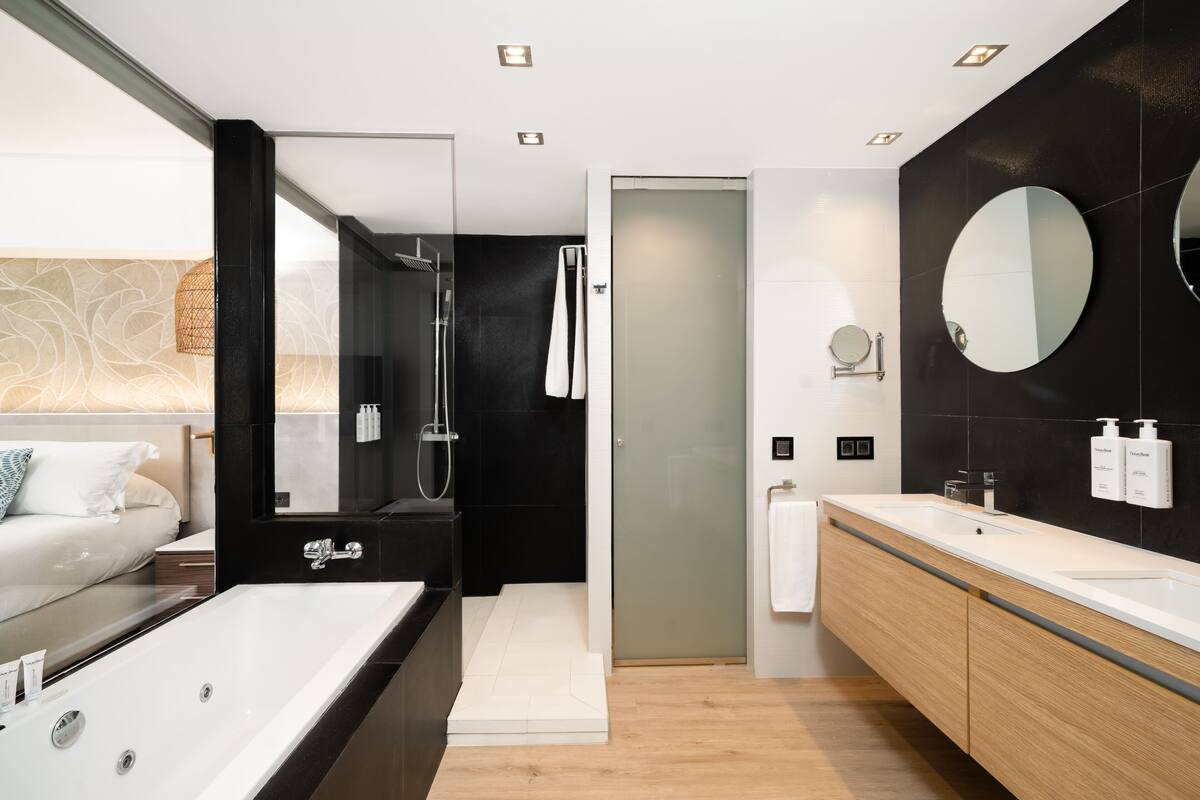 separate bathtub and shower, designer toiletries, hair dryer, bathrobes