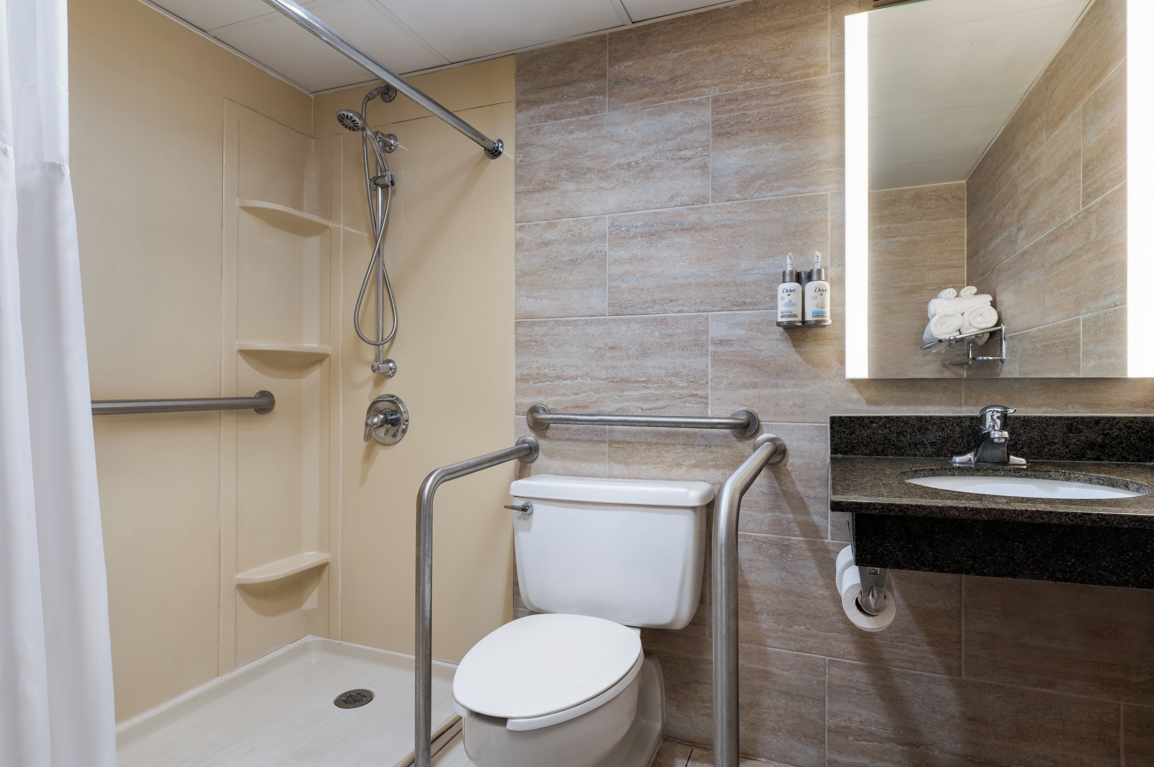 A bathroom with a shower, toilet, and sink.