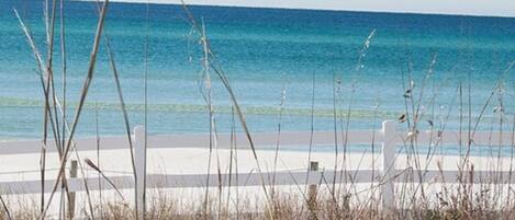 A beach view with a clear sky and calm sea.