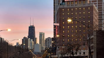 A hotel with a prominent sign, tall buildings, and a city skyline in the background.