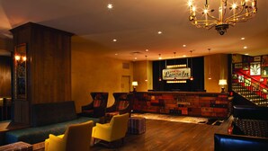 A hotel lobby with a reception desk, a staircase, and seating areas. - Hotel Lincoln (Chicago)