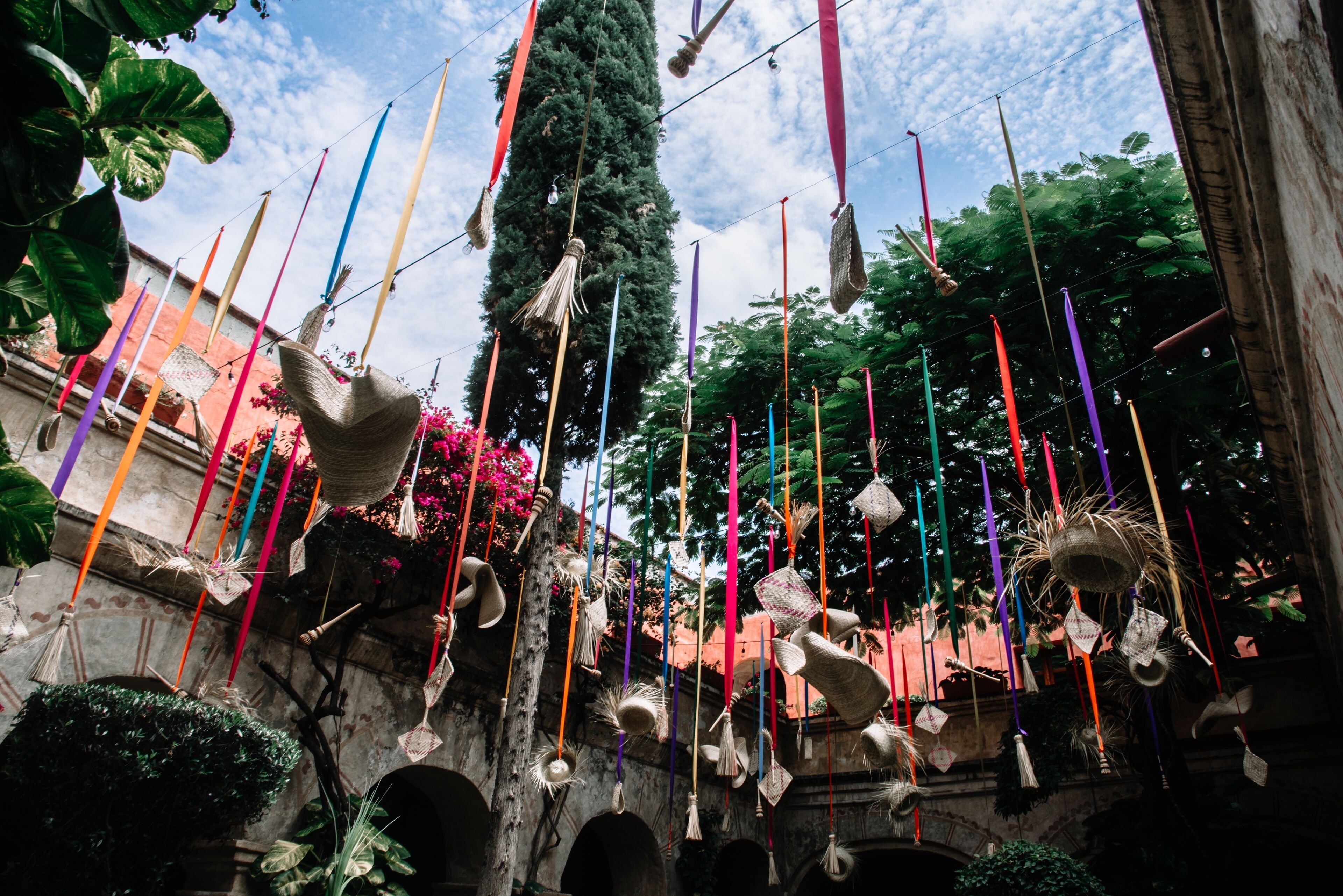 A courtyard with hanging decorations and a tree.