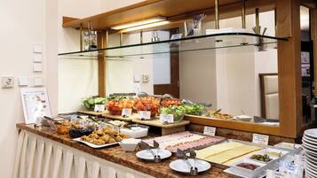 A buffet with various food options, including salads, meats, and cheeses.