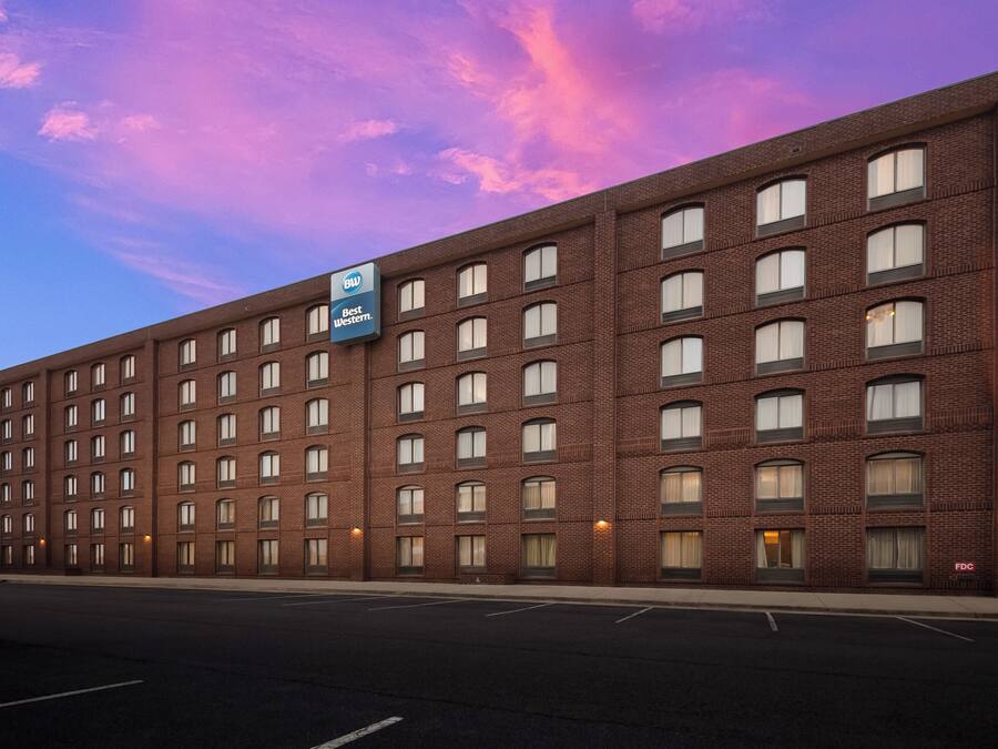 A large brick building with multiple windows and a Best Western sign.