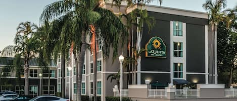 A hotel with a modern design, featuring a prominent sun emblem on the facade.