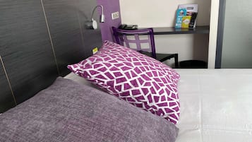 Relax in a stylish room with a comfortable bed, desk, and ample storage.