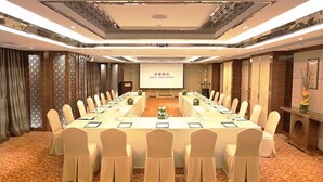 A conference room with a long table, chairs, and a projector screen displaying the Royal Park Hotel name. - Royal Park Hotel (Sha Tin)