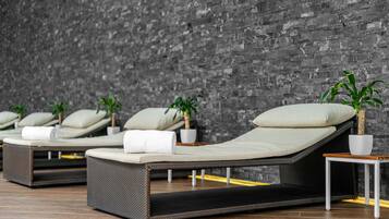 Relax in style with plush lounge chairs and lush greenery.