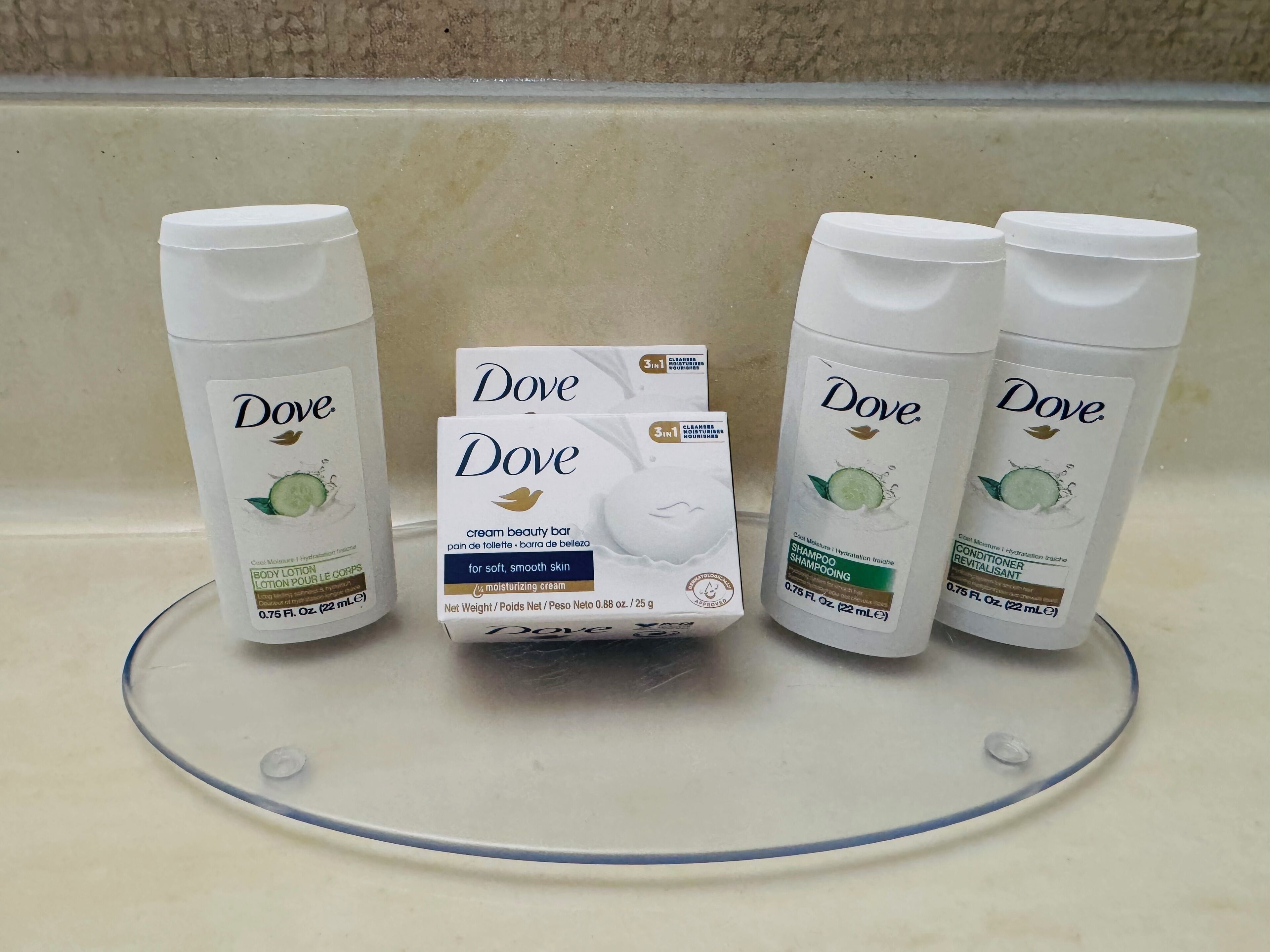Dove body lotion, Dove cream beauty bar, and Dove shampoo on a bathroom counter.