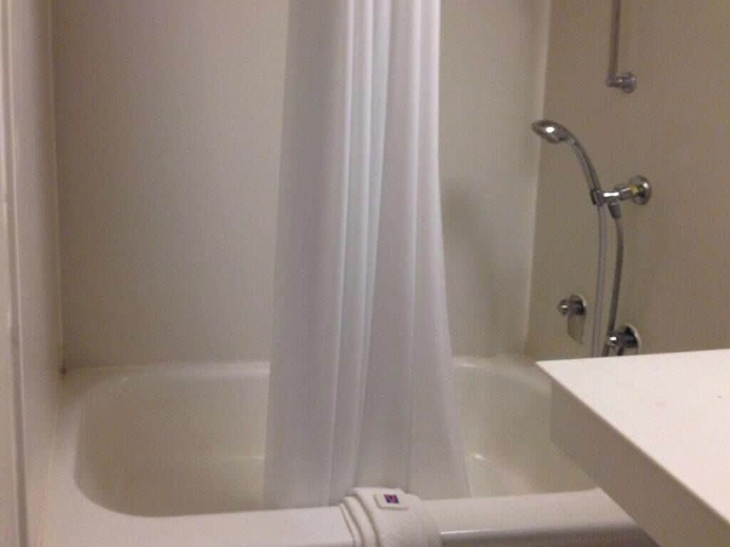 A bathroom with a bathtub, a shower, and a toilet.