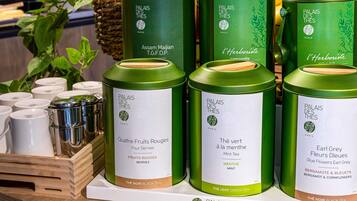 A display of tea tins with labels indicating different flavors and types.