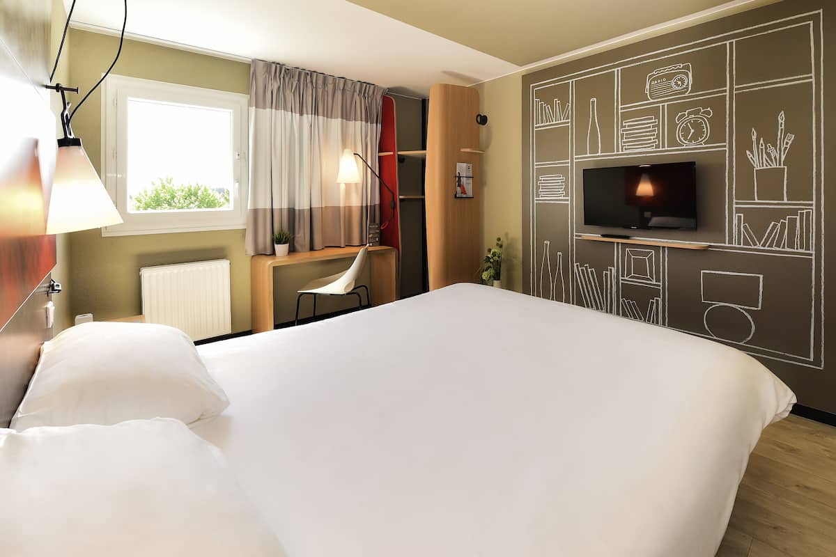 Premium bedding, desk, laptop workspace, blackout curtains