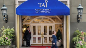 The entrance to the Taj Hotel in San Francisco, featuring a prominent blue awning and a red carpet leading to the doors. - Taj Campton Place (San Francisco)