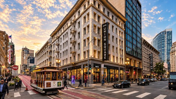 A historic building with a prominent 'HOTEL UNION SQUARE' sign, a tram line, and modern high-rise buildings in the background.