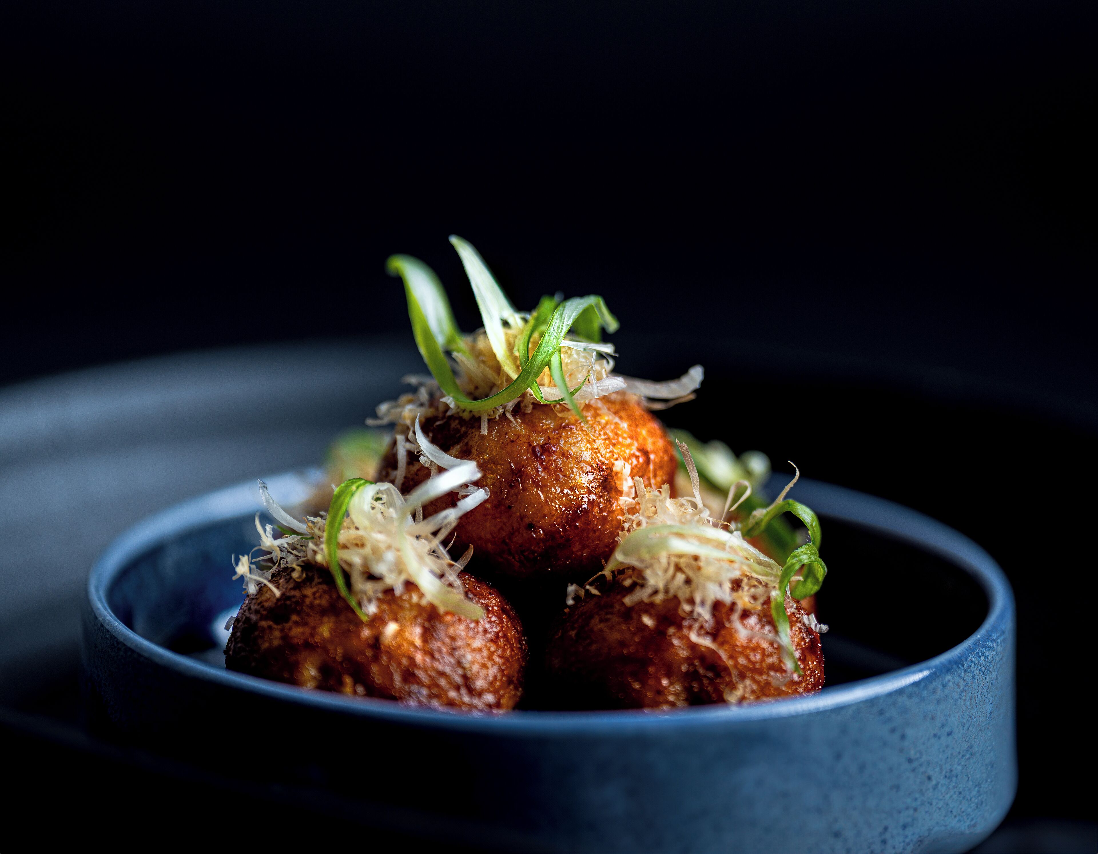 A bowl of food with a dark background.