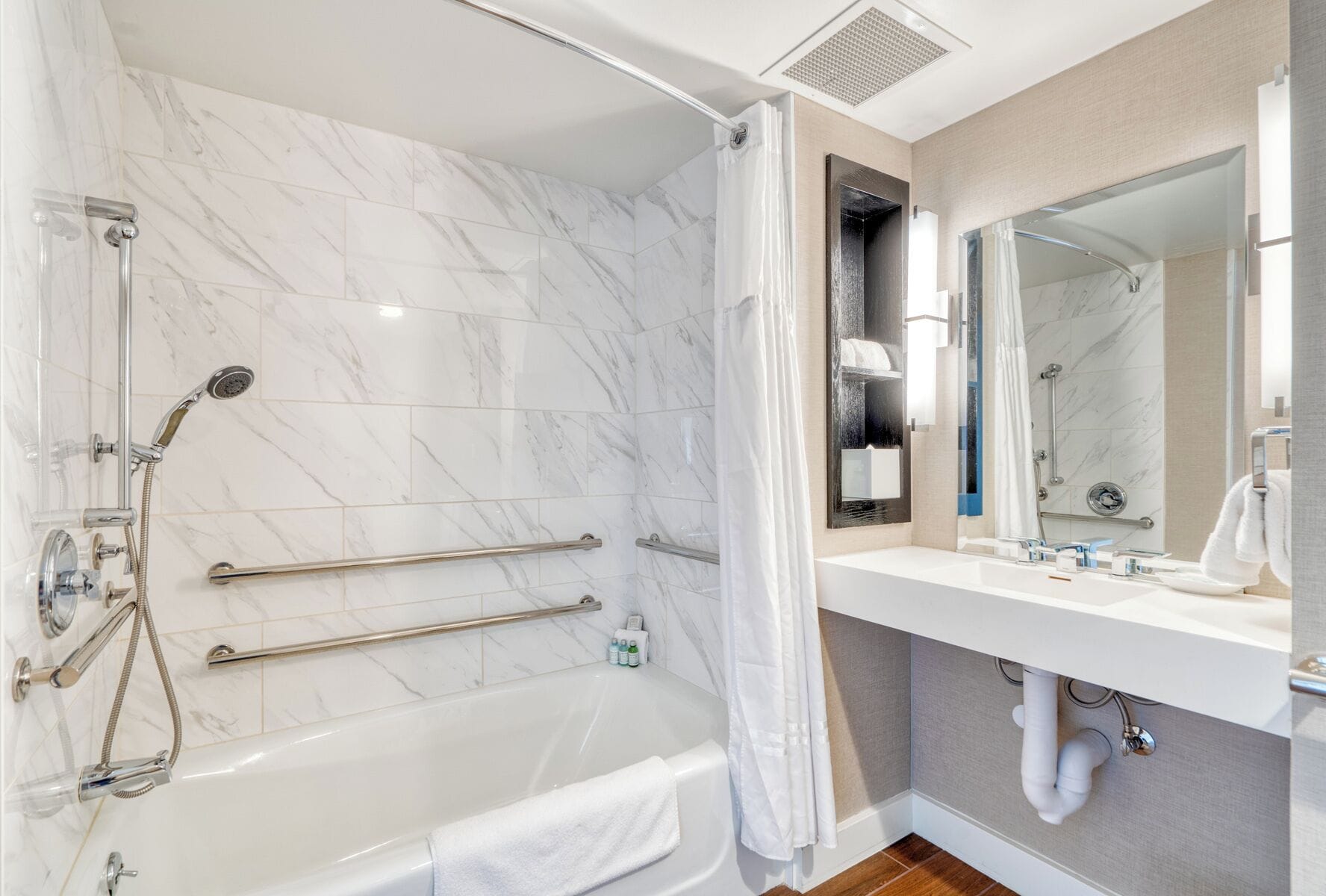 deluxe room, 1 queen bed, accessible | bathroom | designer toiletries, hair dryer, slippers, towels