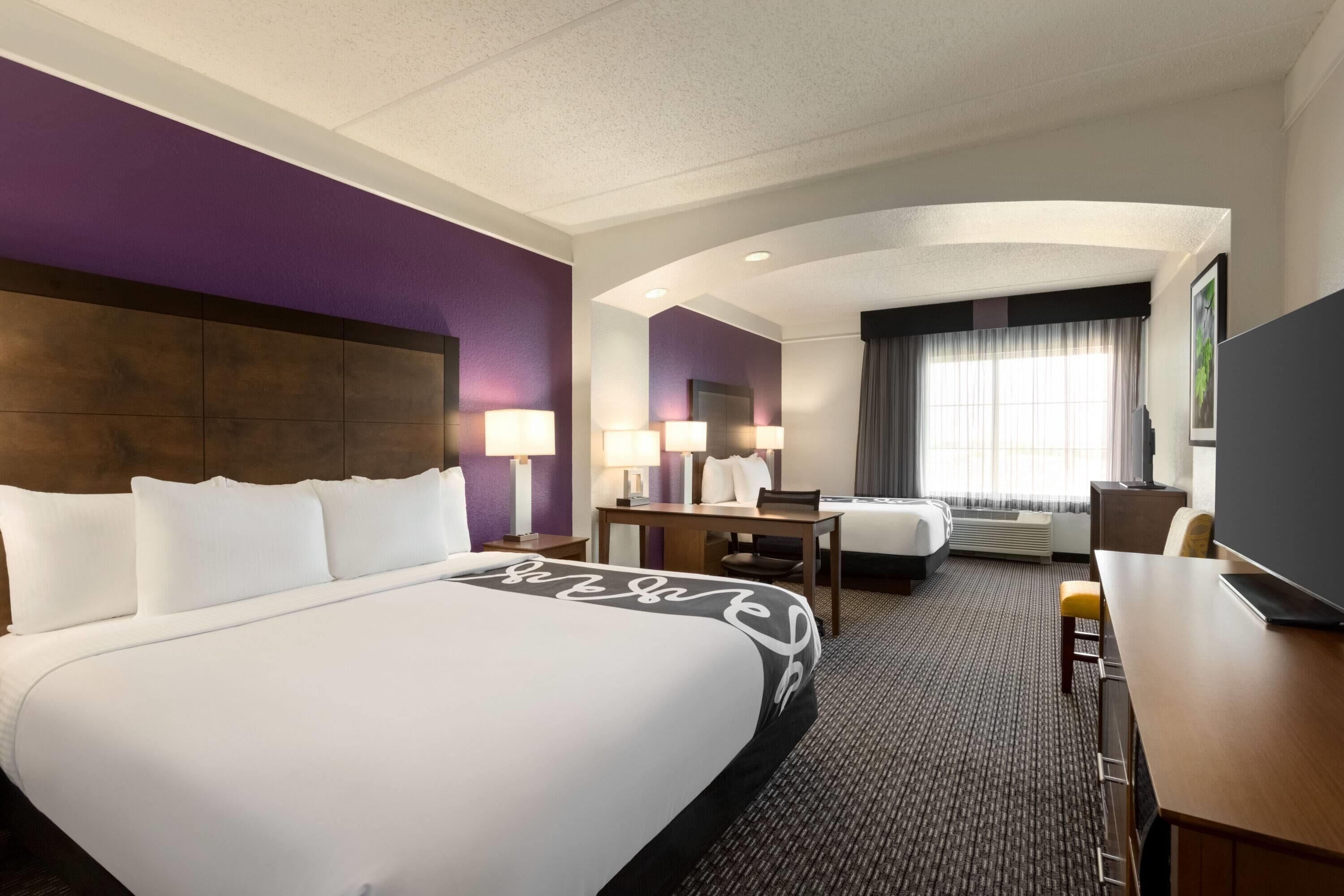 deluxe room, multiple beds, non smoking (1 king bed and 1 full bed) | premium bedding, desk, blackout curtains, iron/ironing board