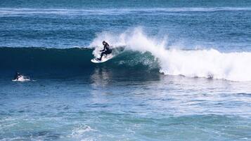 A surfer riding a wave in the ocean.