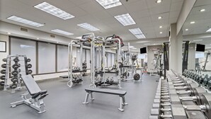 A gym with various weightlifting equipment, benches, and dumbbells. - Crowne Plaza Executive Center Baton Rouge by IHG (Baton Rouge)