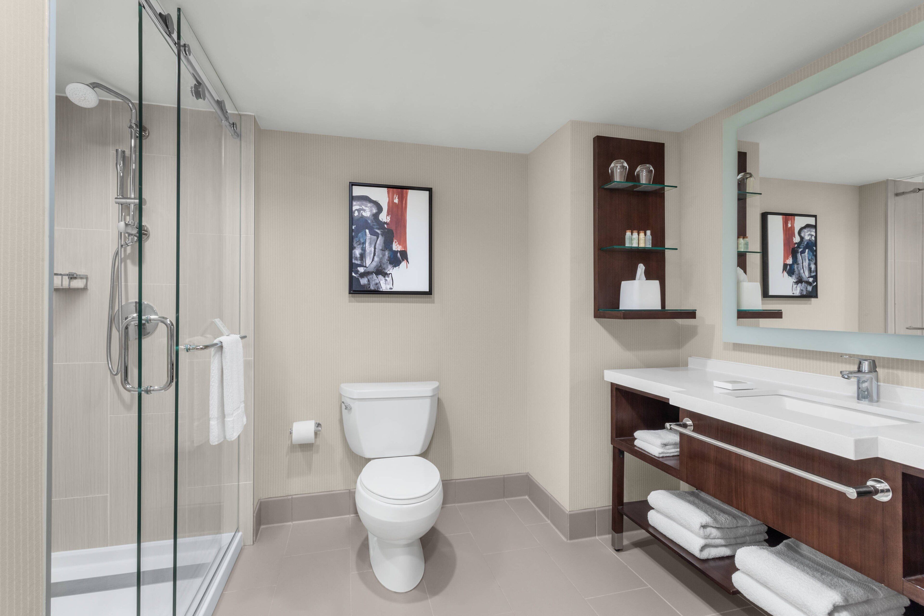 combined shower/bathtub, designer toiletries, hair dryer, towels