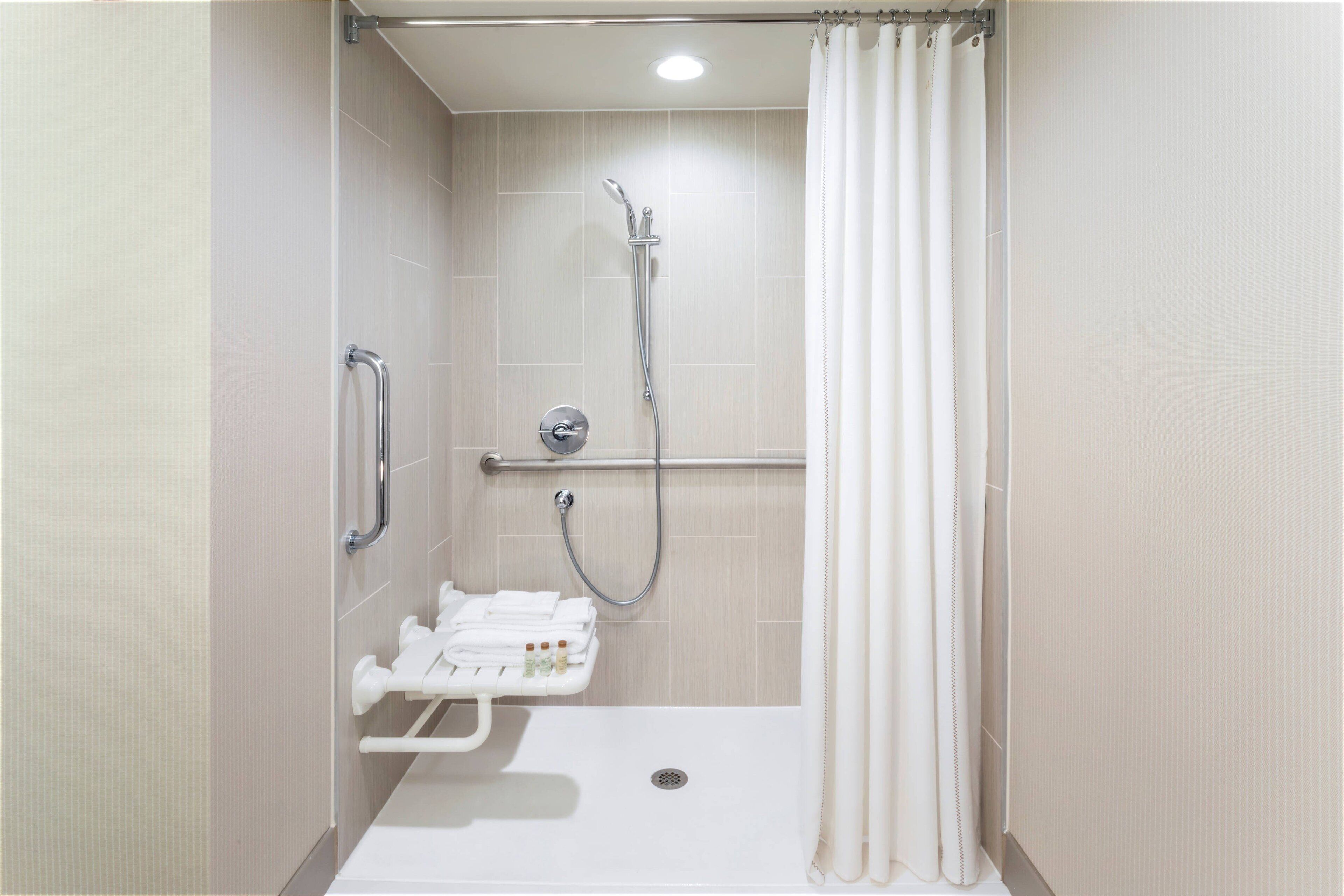 combined shower/bathtub, designer toiletries, hair dryer, towels