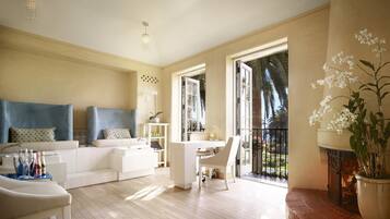 Relax in this stylish living area with a sofa, coffee table, and dining space, offering a view of the outdoors from the balcony.