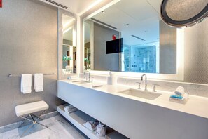 A modern bathroom with a large mirror, two sinks, and a bench. - THE MIDLAND HOTEL, Chicago, a Tribute Portfolio Hotel (Chicago)