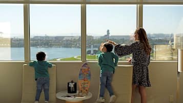 Enjoy a panoramic view of the city and water from the large windows in this stylish room.