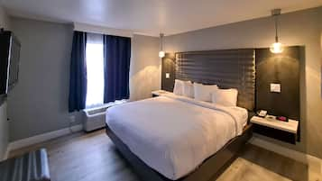 Suite, 1 King Bed, Non Smoking | Desk, laptop workspace, blackout curtains, iron/ironing board