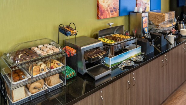 A buffet with various food items, including pastries, sandwiches, and a coffee station. - Comfort Inn New Glasgow - Stellarton (New Glasgow)
