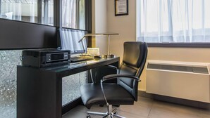 A modern office space with a glass desk, black office chair, and a framed certificate on the wall. - Comfort Inn New Glasgow - Stellarton (New Glasgow)