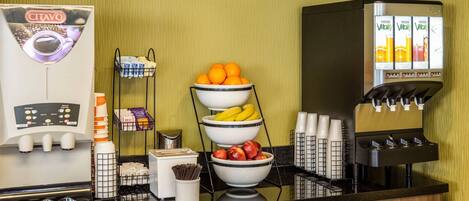 A coffee station with a CITAVO coffee machine, a fruit bowl, and a juice dispenser.
