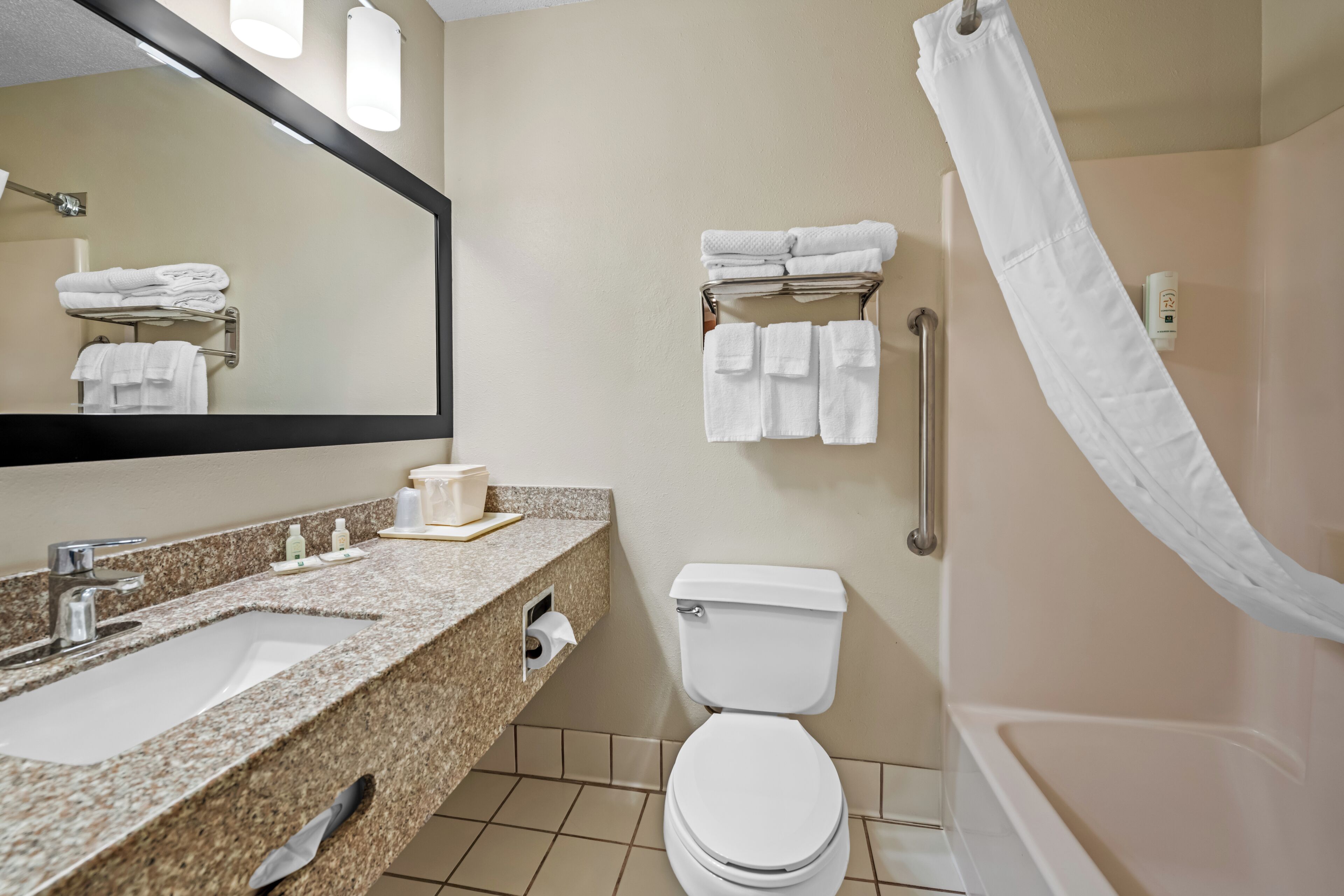 A bathroom with a sink, toilet, and shower.