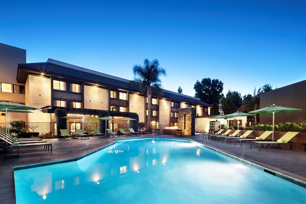 Outdoor pool, a heated pool, pool umbrellas, pool loungers