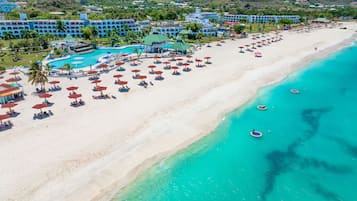 On the beach, white sand, sun-loungers, beach umbrellas