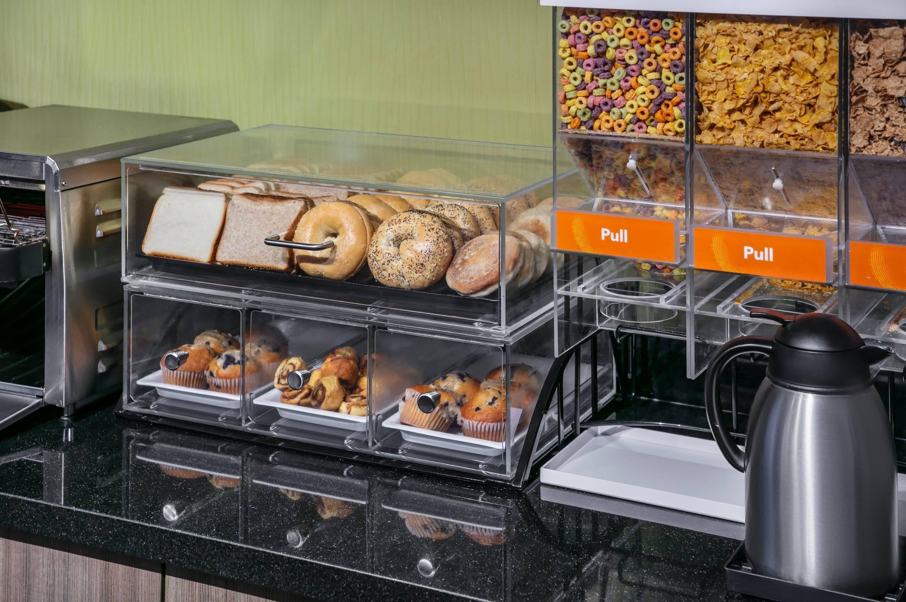 A breakfast buffet with various pastries and cereals.