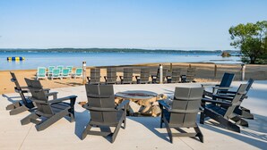 A beachside seating area with lounge chairs and a fire pit. - Grand Traverse Resort And Spa (Williamsburg)