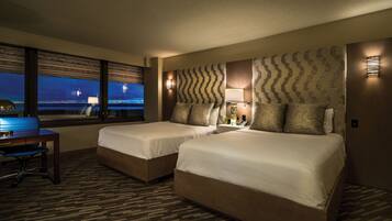 Premium bedding, desk, laptop workspace, blackout drapes