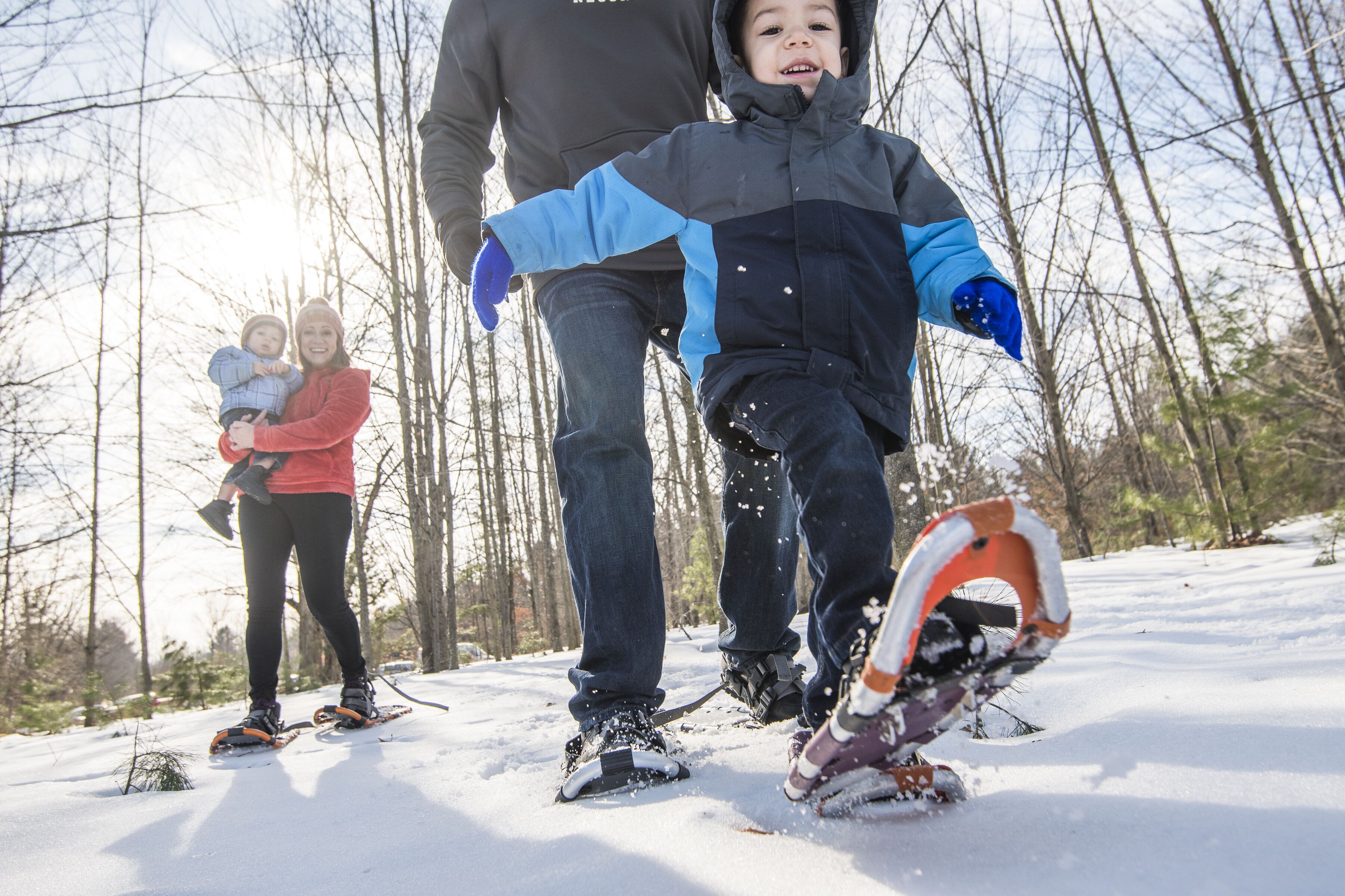 A snowy outdoor scene with people using snowshoes.