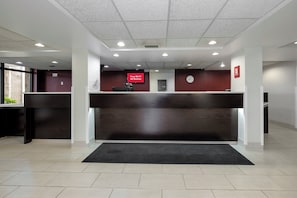 A reception desk with a digital clock, a notice board, and a sign indicating free Wi-Fi availability. - Red Roof Inn Gadsden (Gadsden)