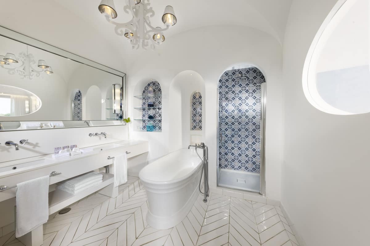 junior suite (sea side) | bathroom | separate bathtub and shower, rainfall showerhead, free toiletries