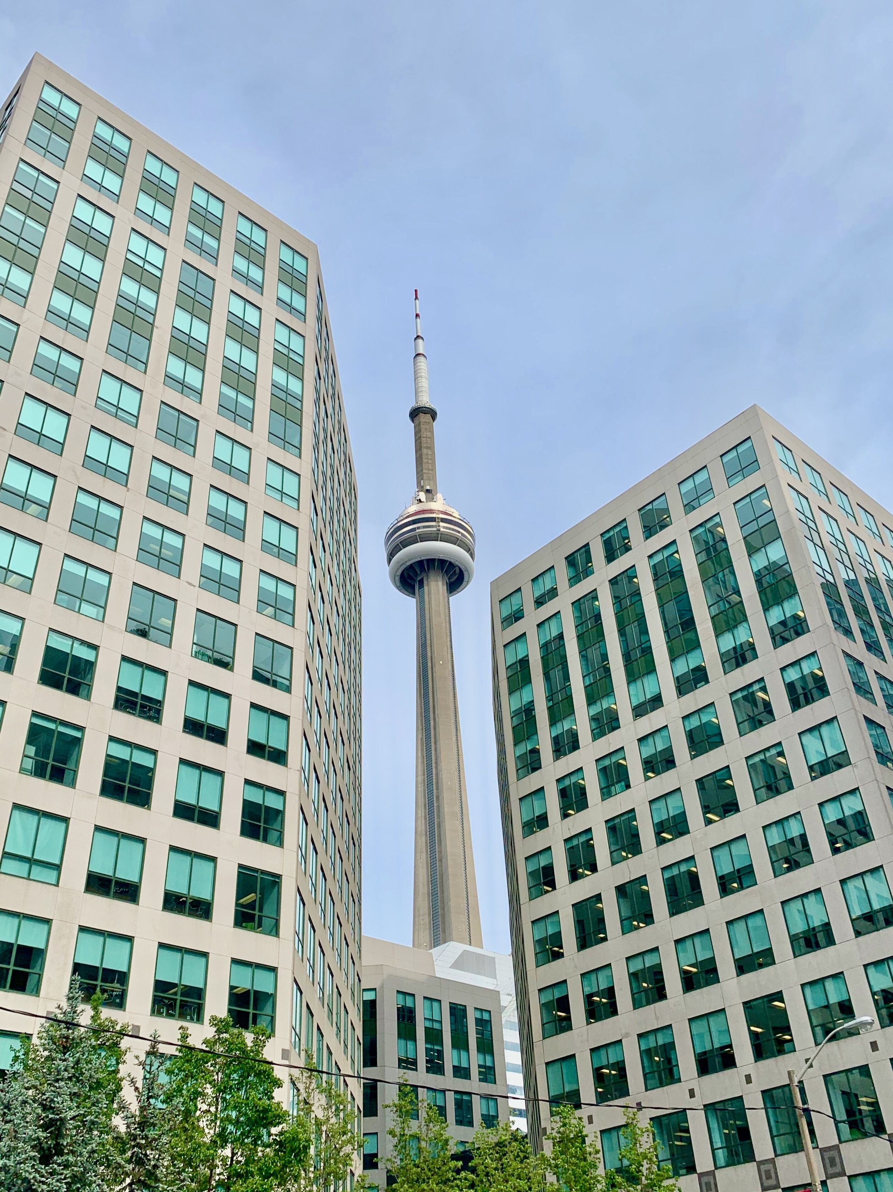 A modern high-rise building with a prominent tower structure in the center.