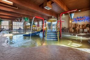 An indoor water park with slides, a climbing area, and a pool. - Comfort Suites Green Bay West (Green Bay)