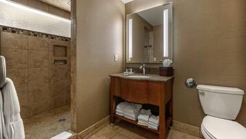 A bathroom with a shower, sink, and toilet.