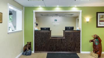 A reception desk with a sign reading "Quality Inn & Suites."