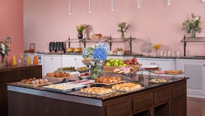 A buffet with various food items and a decorative vase. - NH Ancona (Ancona)