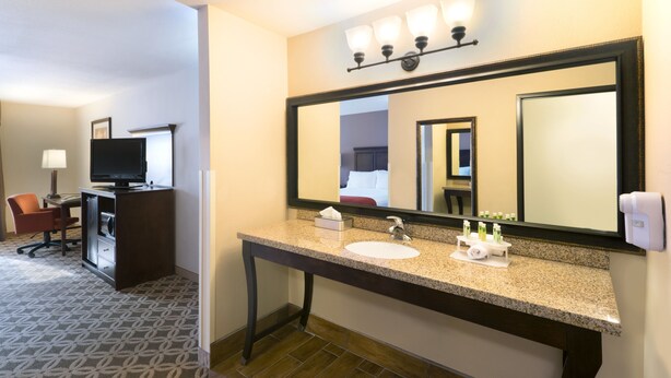 A hotel bathroom with a sink, mirror, and toiletries. - Holiday Inn Express Show Low by IHG (Show Low)