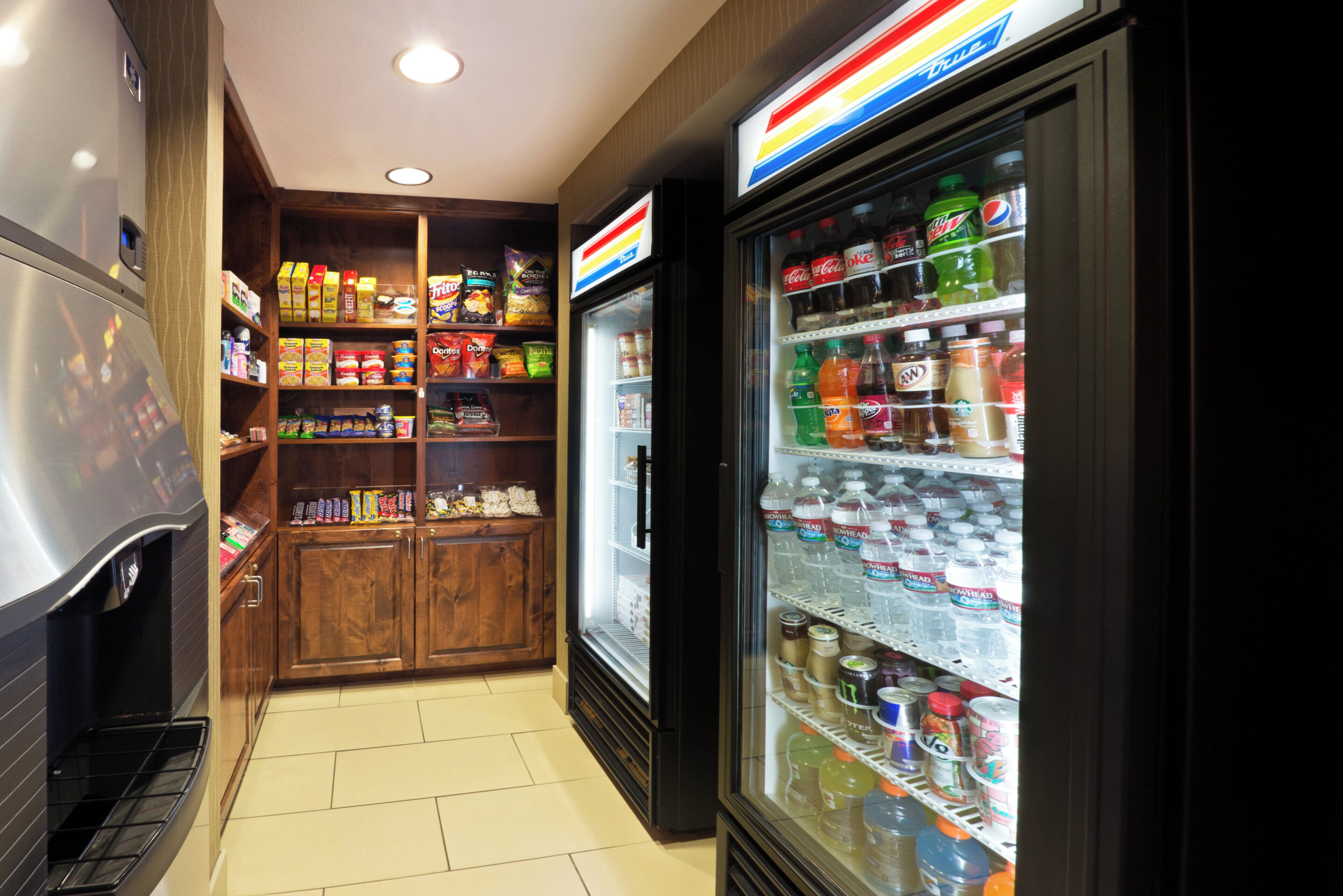 A vending machine area with snacks and drinks, including a refrigerator stocked with beverages.