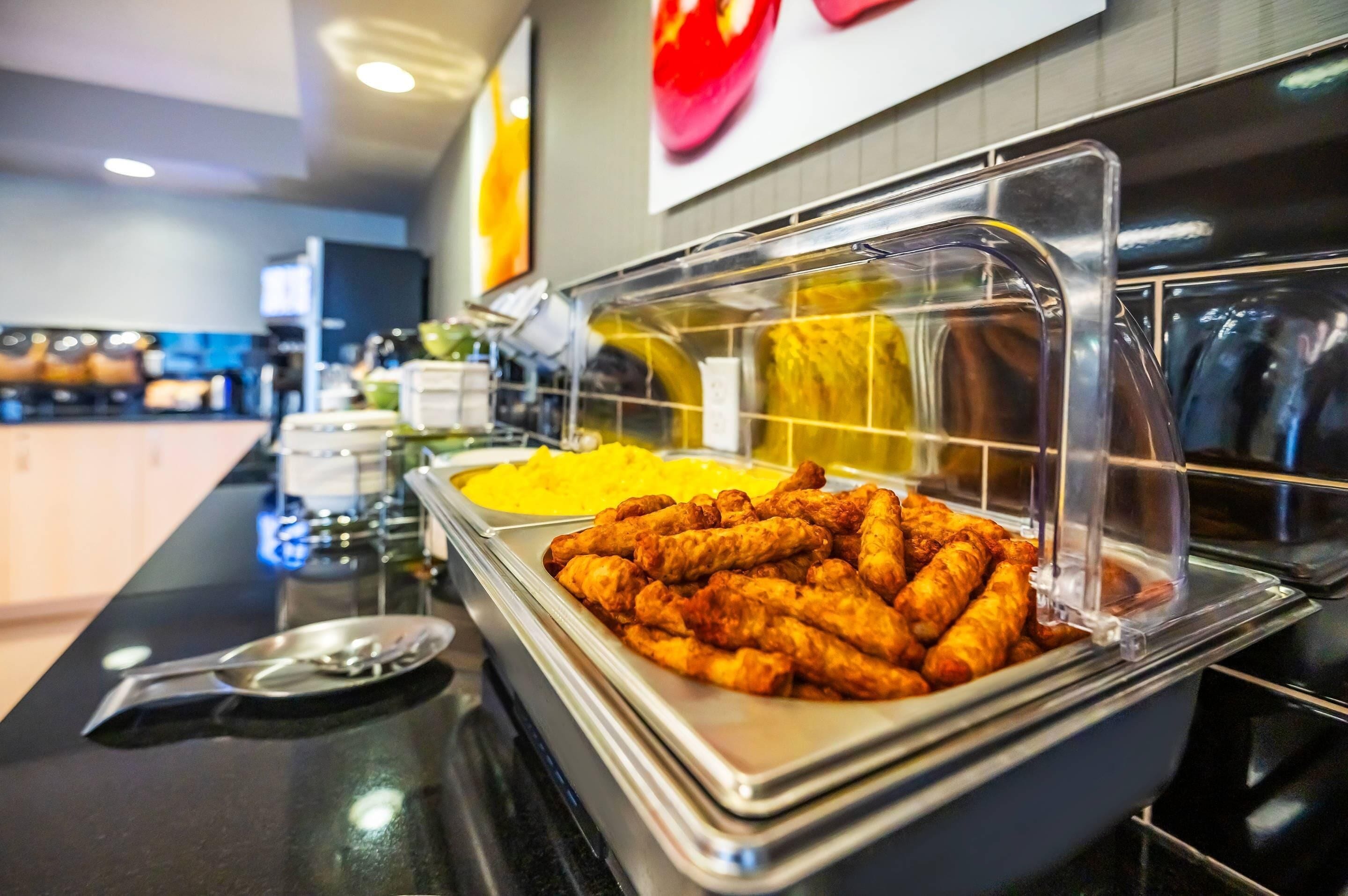 A buffet with various food items including fried chicken and mashed potatoes.