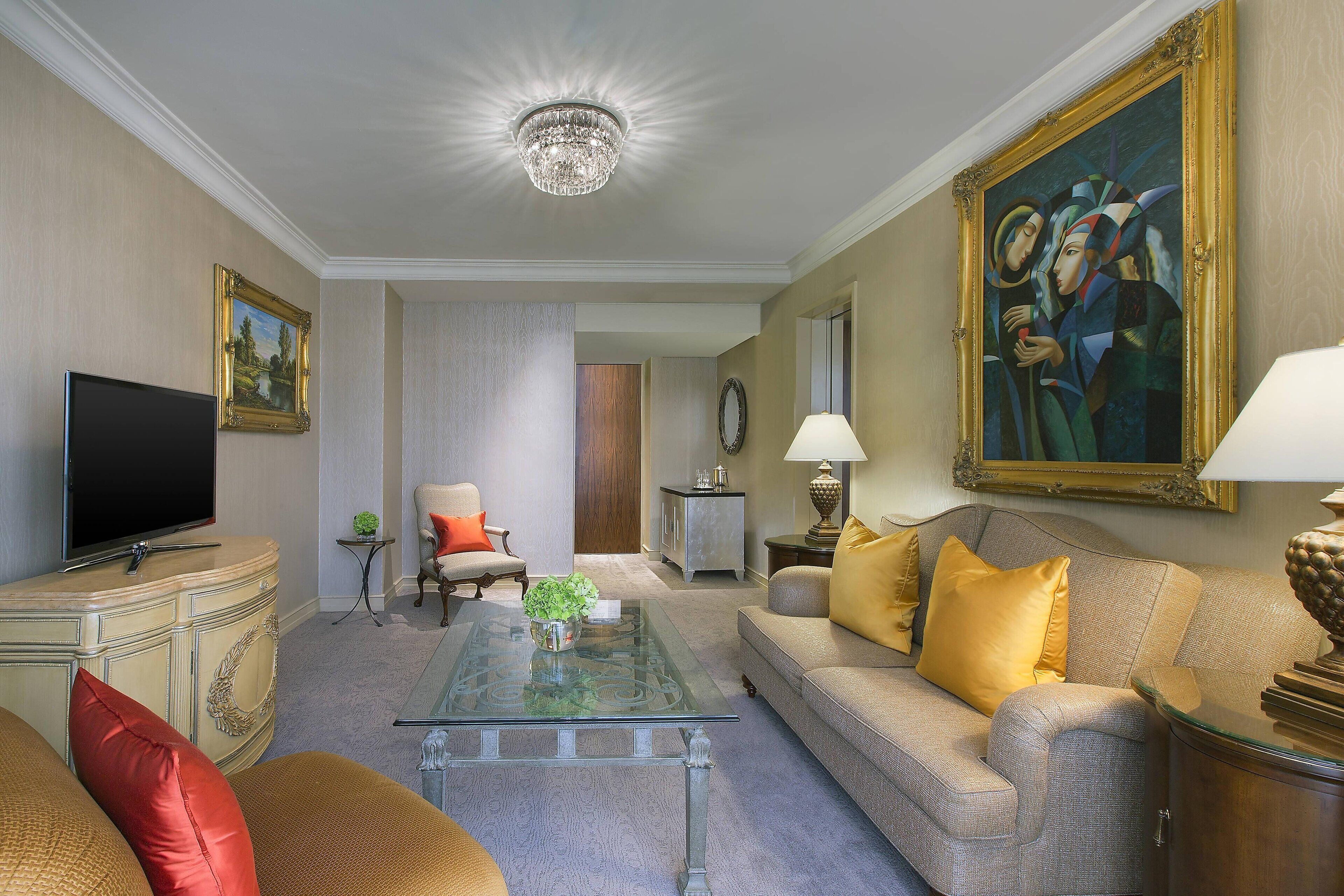 A living room with a television, sofa, and coffee table.